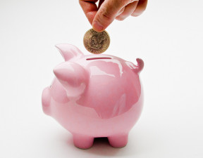 piggy bank Hand Putting Deposit Into Piggy Bank