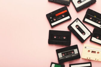 vintage audio cassette tapes on light pink background