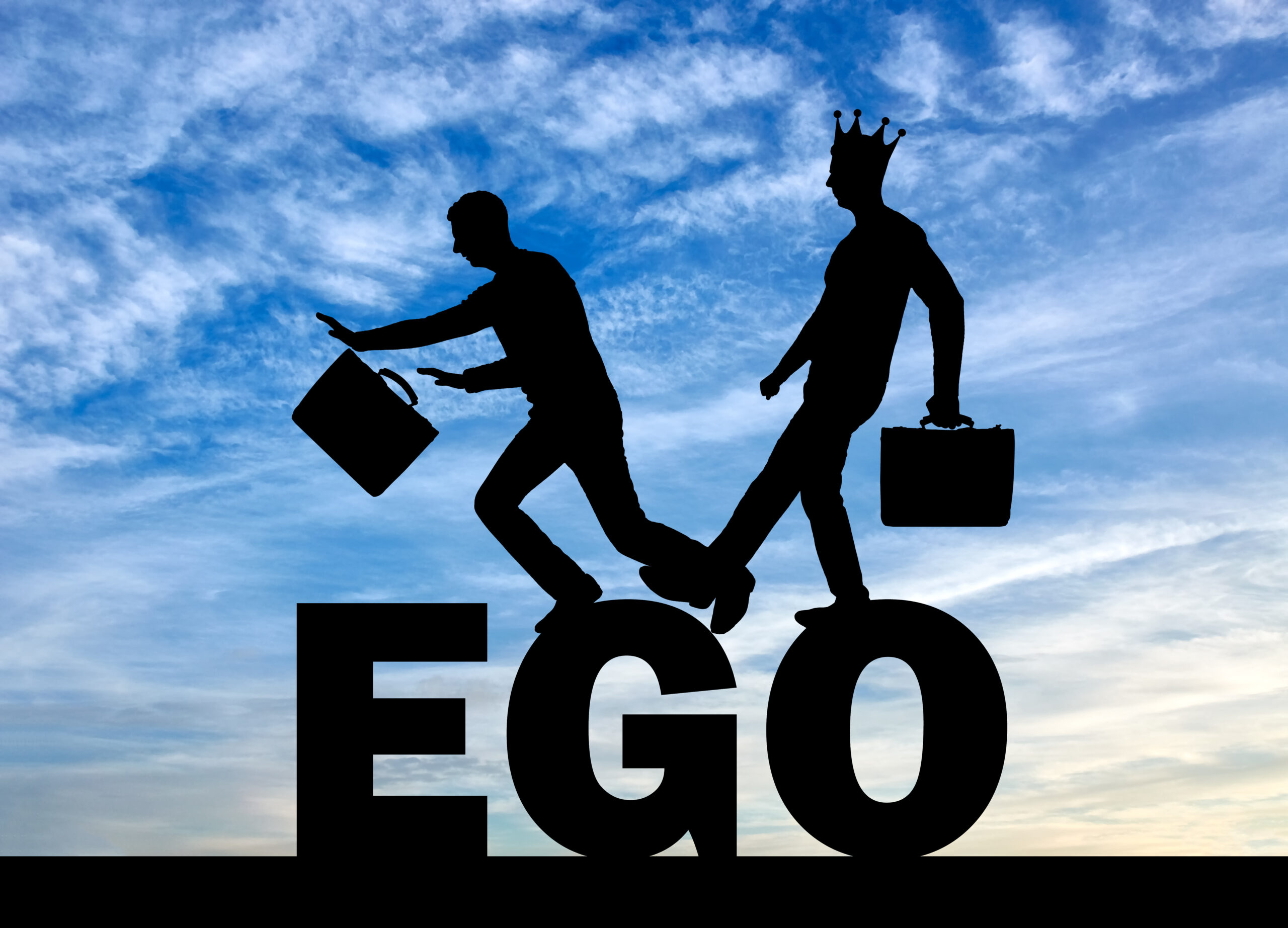 silhouettes of two business man standing on the word EGO
