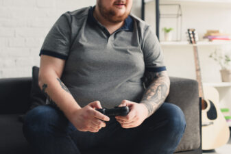 fat man playing video games