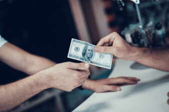 closeup of handing money