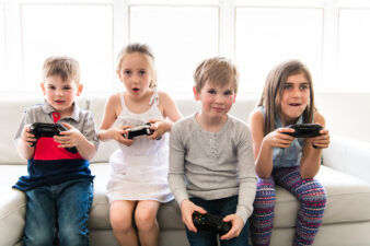 kids sitting and playing video games
