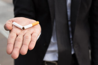 man holding a cigarette split in half 