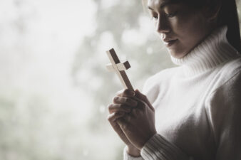 woman holding a cross