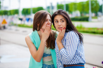 two young women gossiping
