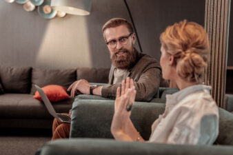 man and woman talking in a living room