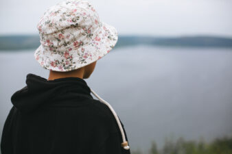 back view of teenage boy wearing a floral bucket hat