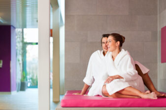 young couple in bathrobes at a spa