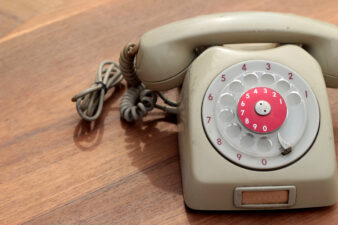 vintage tan rotary phone on wood background