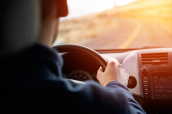 man driving with two hands on the wheel