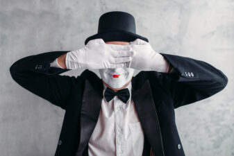 mime posing with his hands over his eyes