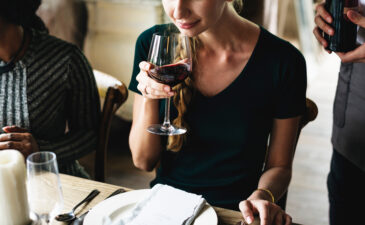 woman sipping a glass of red wine