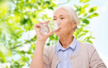 older woman drinking a glass of water