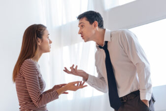 Irritated angry man giving arguments to his emotional wife