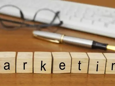 The word marketing spelled out in blocks on a desk