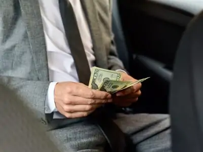 man counting dollar bills