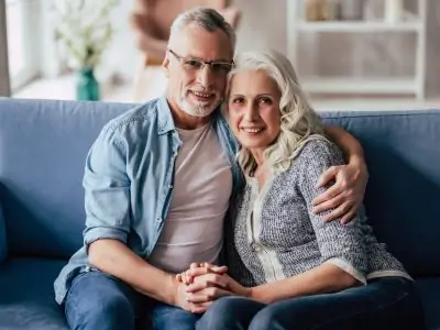 Senior couple at home on couch