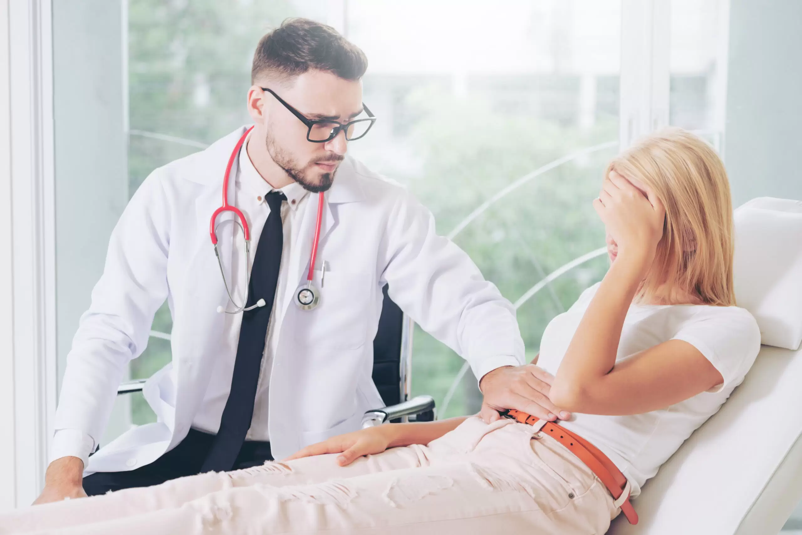 Male Doctor and Female Patient in Hospital Office